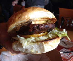 The Guerrilla Burger Hickory smoke pork burger, chipotle cream cheese guerrilla slaw, heat-seeking mustard